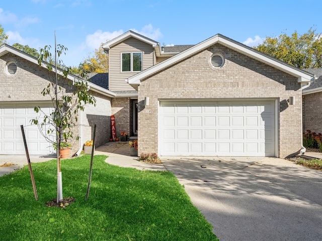 view of front of home with a front yard and a garage