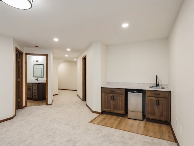 bar with light carpet, dishwasher, and sink