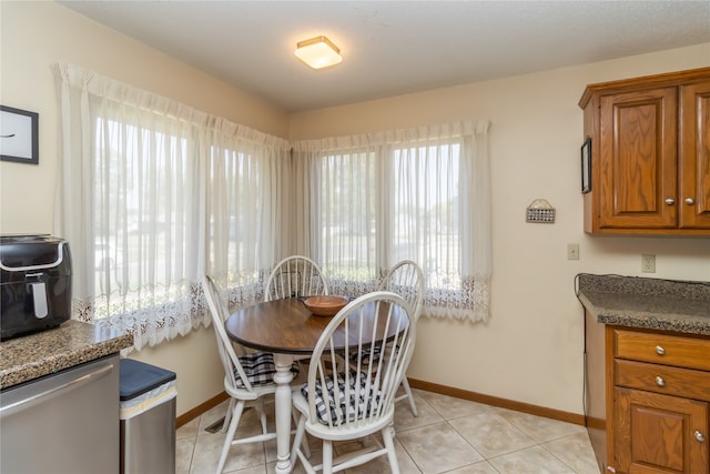 dining area with light tile patterned floors