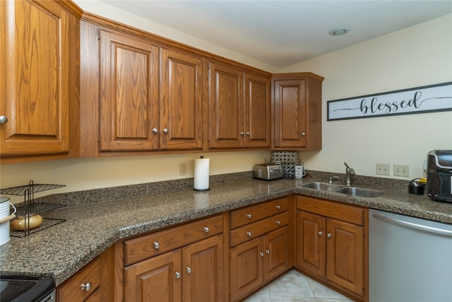 kitchen featuring light tile patterned floors, sink, and stainless steel dishwasher