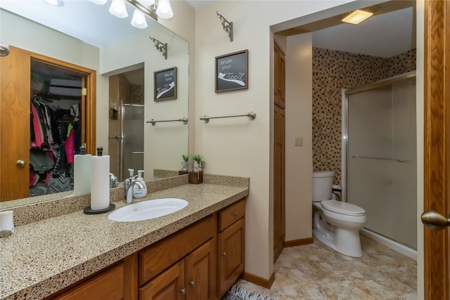 bathroom featuring vanity, walk in shower, and toilet