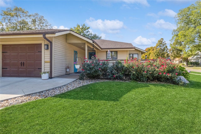 ranch-style home featuring a garage and a front lawn