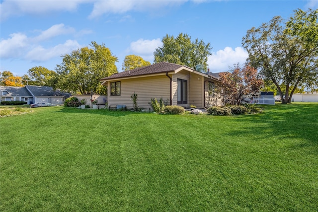 back of property featuring a yard