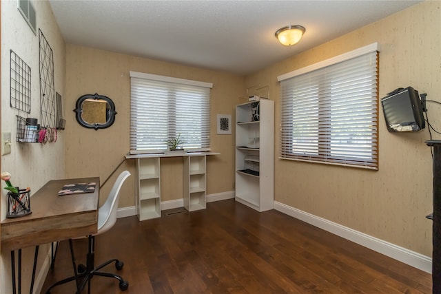 home office with dark hardwood / wood-style floors