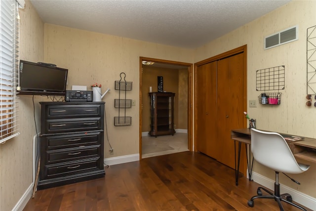 office area with a textured ceiling and dark hardwood / wood-style flooring