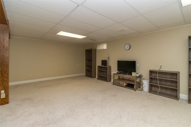 basement with a drop ceiling and carpet