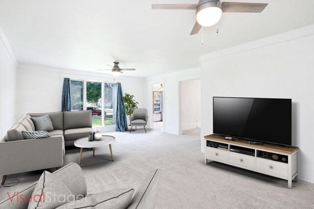 living room with ceiling fan, light colored carpet, and ornamental molding