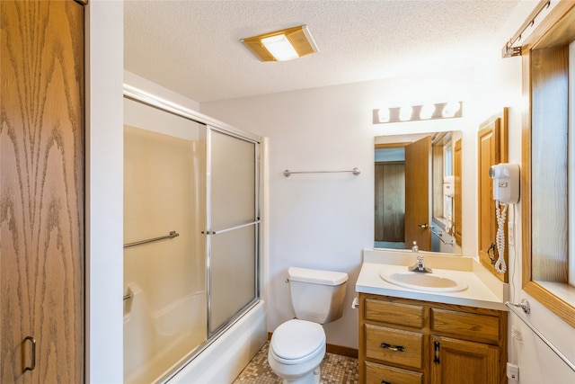 full bathroom featuring tile patterned floors, bath / shower combo with glass door, vanity, a textured ceiling, and toilet