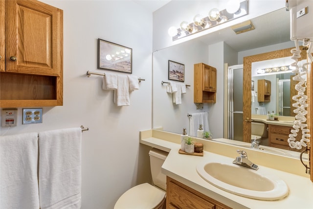 bathroom with vanity, toilet, and walk in shower