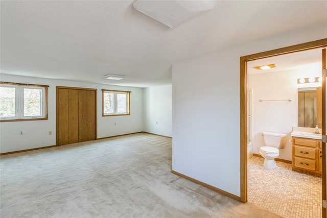 carpeted empty room featuring sink