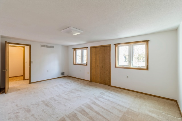 unfurnished room with light carpet and a healthy amount of sunlight