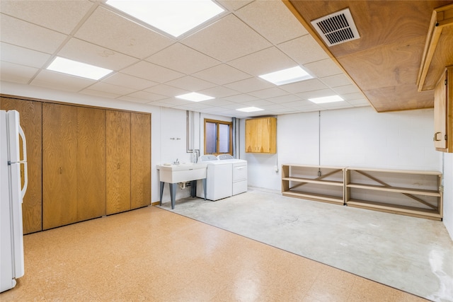 laundry area with cabinets, independent washer and dryer, and sink