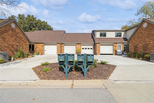 front of property featuring central AC unit and a garage