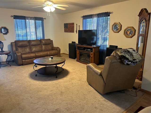 living room featuring ceiling fan, carpet, and plenty of natural light