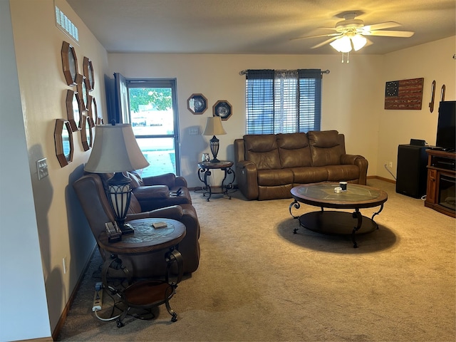 living room featuring carpet and ceiling fan