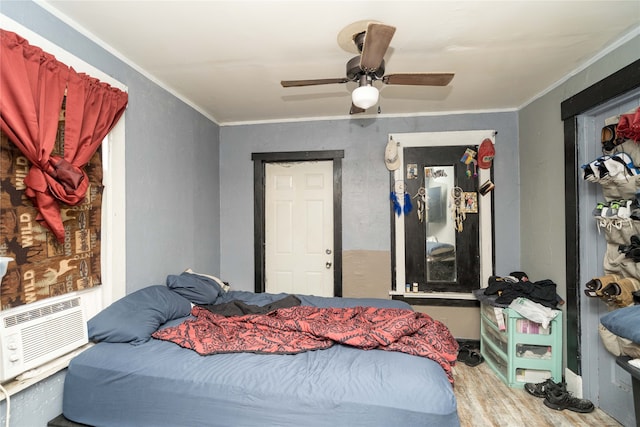 bedroom with ceiling fan, cooling unit, and ornamental molding