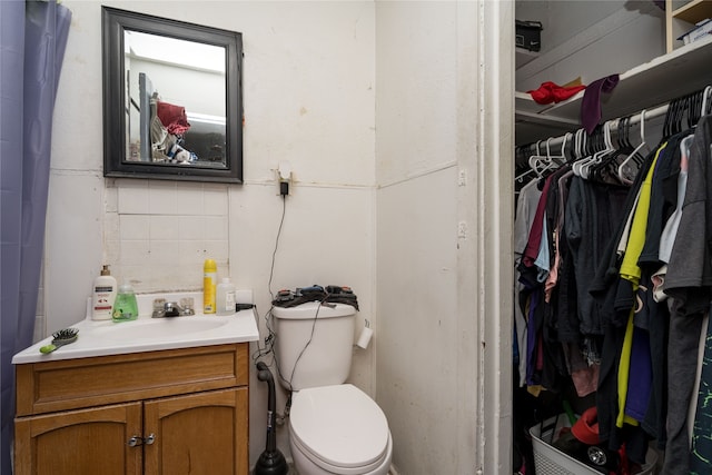 bathroom featuring toilet and vanity