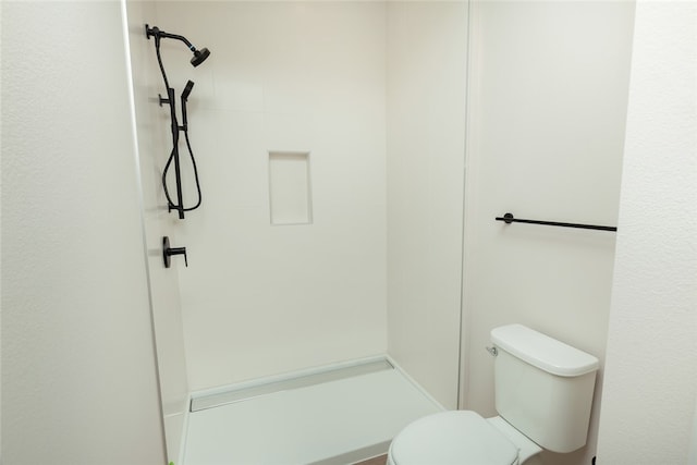 bathroom with toilet and walk in shower