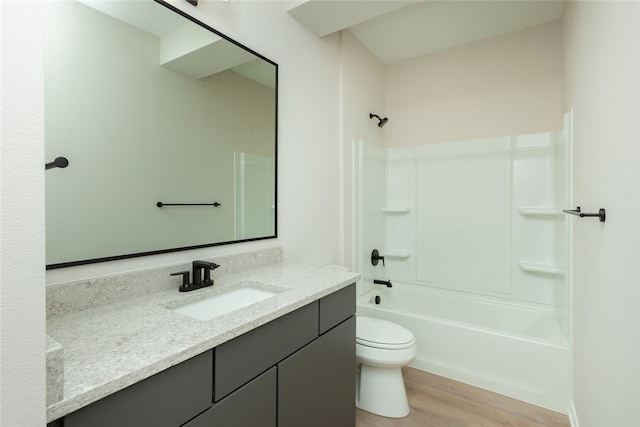 full bathroom featuring hardwood / wood-style floors, toilet, washtub / shower combination, and vanity