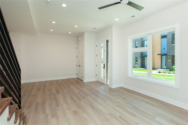 unfurnished room with ceiling fan and light hardwood / wood-style floors