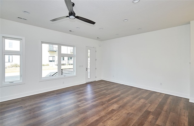 unfurnished room with ceiling fan, dark hardwood / wood-style floors, and a textured ceiling