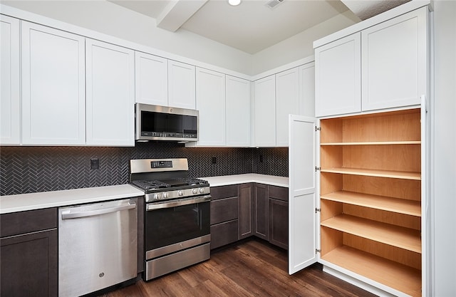 kitchen featuring decorative backsplash, white cabinets, appliances with stainless steel finishes, and dark hardwood / wood-style flooring