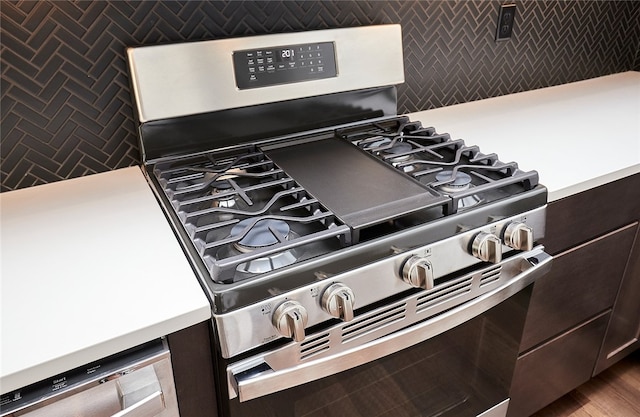 interior details with dark brown cabinets and stainless steel range with gas stovetop