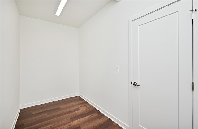 empty room with dark hardwood / wood-style flooring