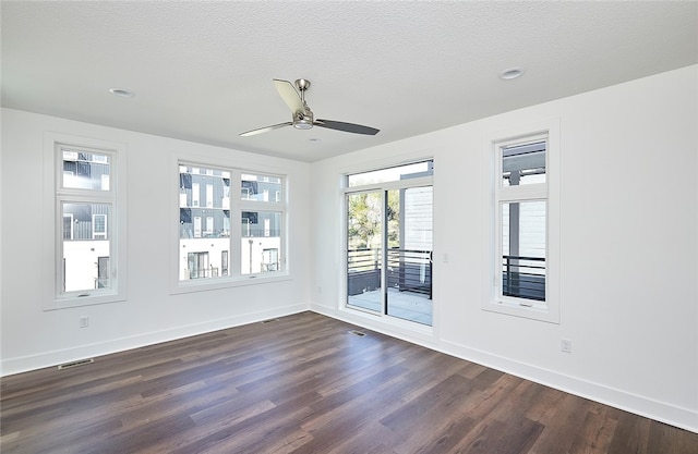 unfurnished room with dark wood-type flooring, ceiling fan, and a textured ceiling