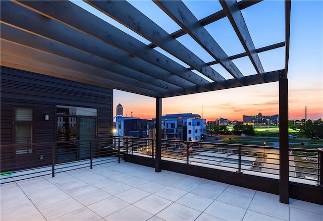 patio terrace at dusk featuring a pergola