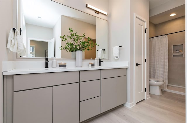 bathroom with vanity, toilet, hardwood / wood-style floors, and a shower with shower curtain