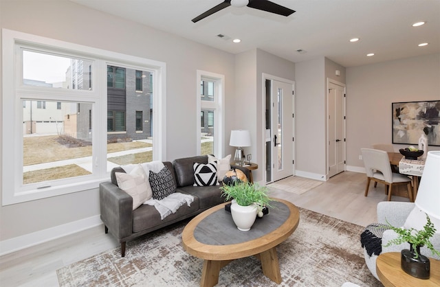 living room featuring light hardwood / wood-style floors and ceiling fan