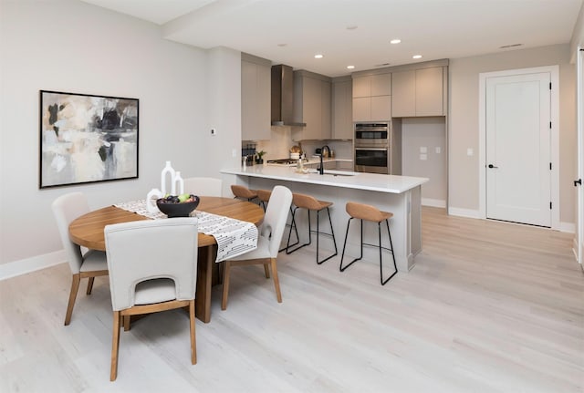 dining room with sink and light hardwood / wood-style floors