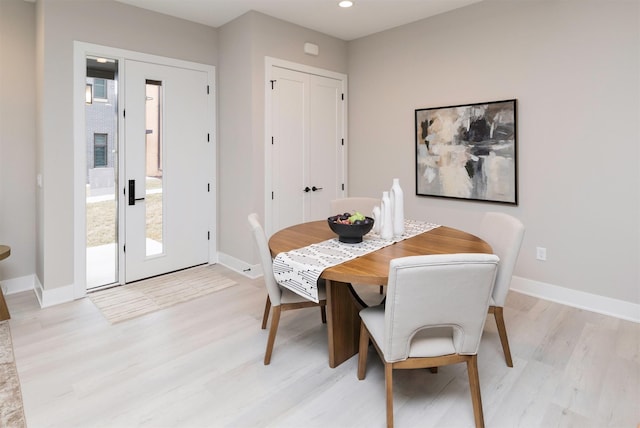 dining room featuring a wealth of natural light and light hardwood / wood-style floors