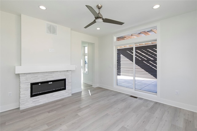 unfurnished living room with ceiling fan and light hardwood / wood-style flooring