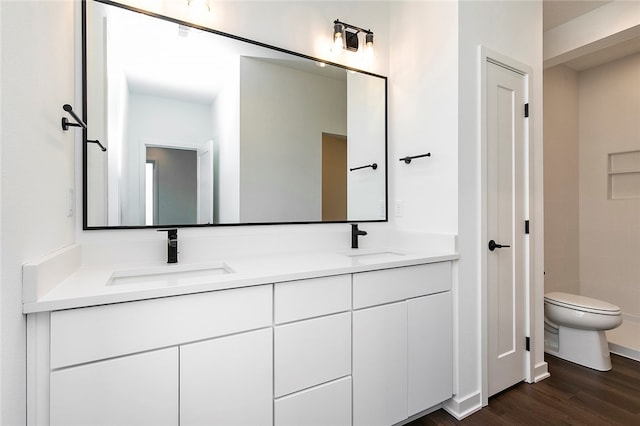 bathroom featuring hardwood / wood-style floors, vanity, and toilet