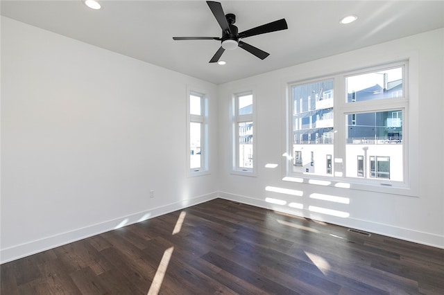 spare room with ceiling fan and dark wood-type flooring