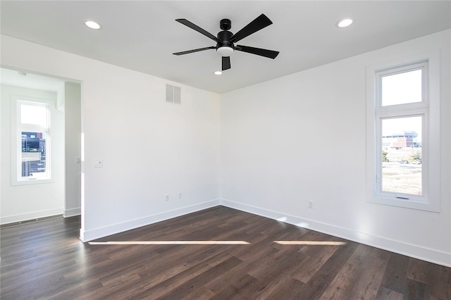 empty room with ceiling fan and dark hardwood / wood-style floors