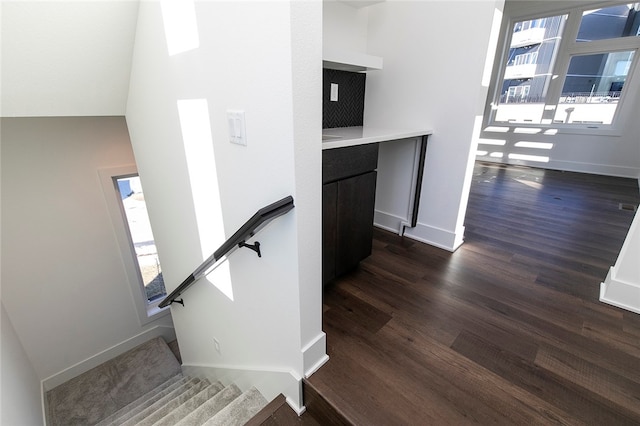 stairs featuring hardwood / wood-style flooring and plenty of natural light