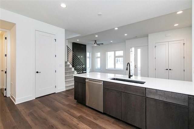 kitchen featuring ceiling fan, sink, dark brown cabinets, dishwasher, and dark hardwood / wood-style floors