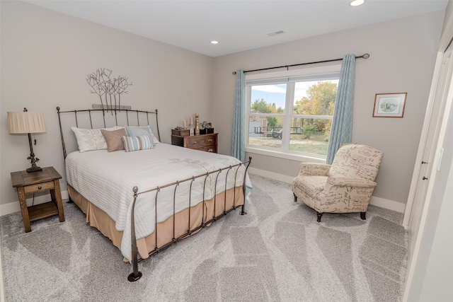 bedroom with a closet and light colored carpet