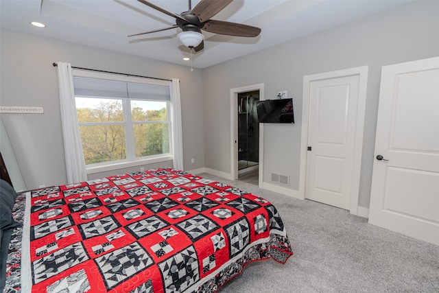 bedroom with ceiling fan, ensuite bath, and carpet