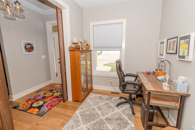 home office with light hardwood / wood-style floors