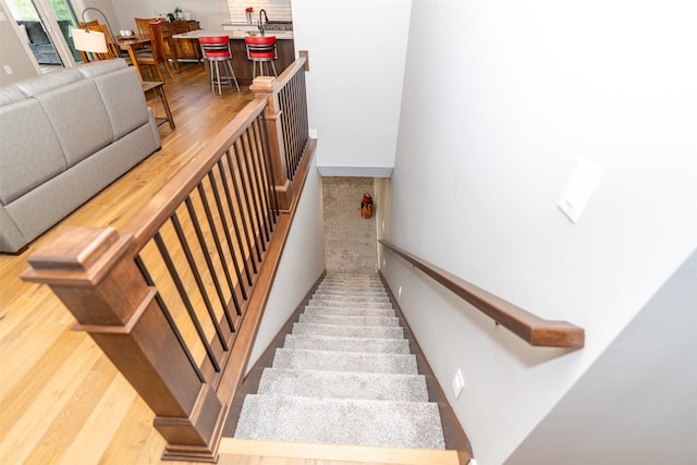 staircase with hardwood / wood-style flooring