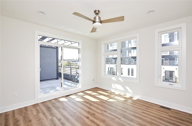 empty room with light wood-type flooring and ceiling fan