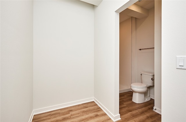 bathroom with toilet and wood-type flooring