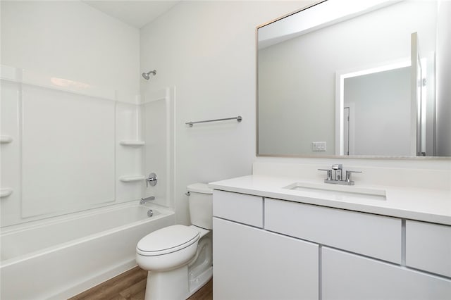 full bathroom with tub / shower combination, hardwood / wood-style floors, vanity, and toilet