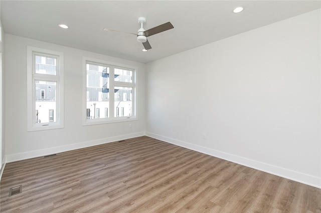 spare room featuring hardwood / wood-style flooring and ceiling fan