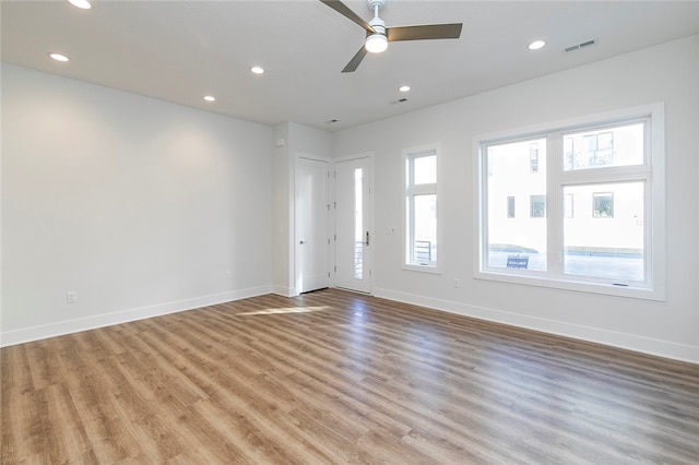 empty room featuring ceiling fan and light hardwood / wood-style flooring