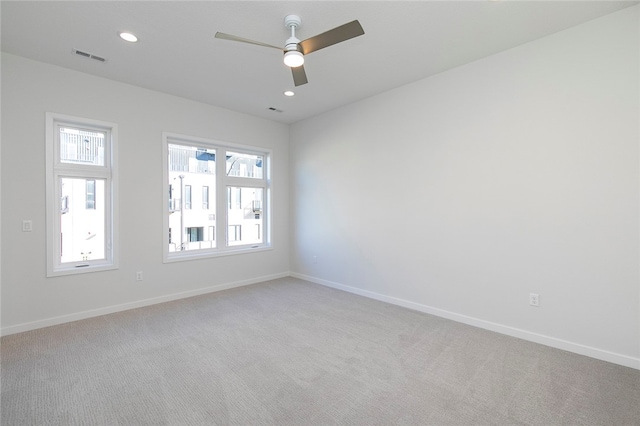 empty room featuring light colored carpet and a wealth of natural light